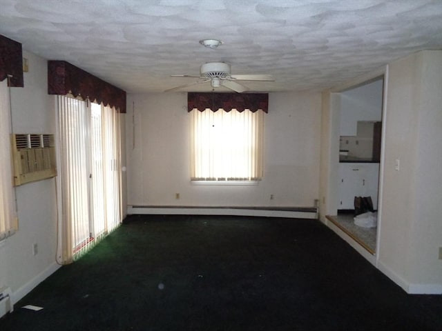 spare room with ceiling fan, a textured ceiling, and baseboard heating