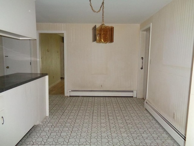 unfurnished dining area featuring baseboard heating