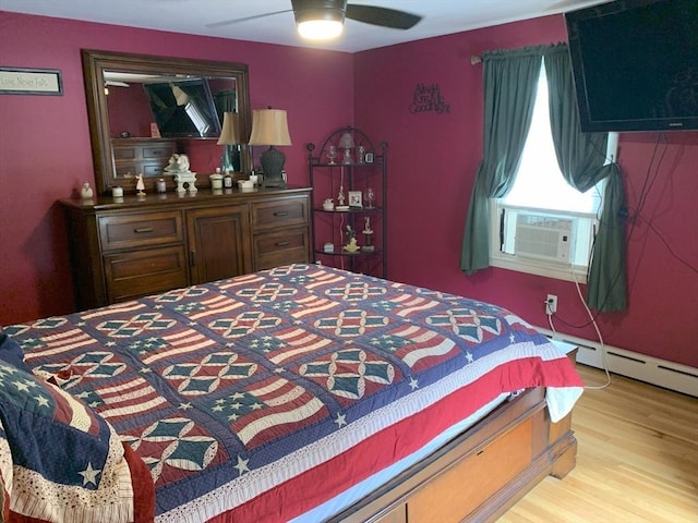 77 Westwood Pkwy, Southbridge, MA 01550 - bedroom featuring cooling unit, wood finished floors, a baseboard heating unit, and ceiling fan