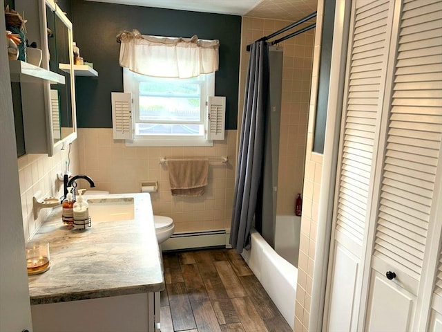 77 Westwood Pkwy, Southbridge, MA 01550 - full bath featuring baseboard heating, tile walls, vanity, shower / bath combo with shower curtain, and wood finished floors