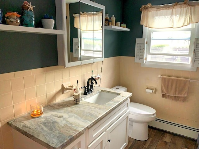 77 Westwood Pkwy, Southbridge, MA 01550 - bathroom featuring a baseboard heating unit, vanity, tile walls, and wood finished floors
