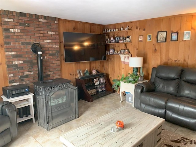 77 Westwood Pkwy, Southbridge, MA 01550 - living room with light tile patterned flooring, wooden walls, and a wood stove
