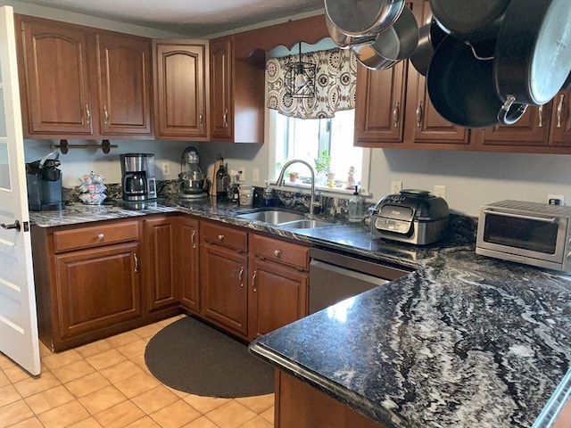 77 Westwood Pkwy, Southbridge, MA 01550 - kitchen featuring brown cabinetry, light tile patterned floors, dishwasher, and dark stone countertops
