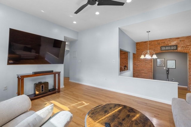 80 Beaumont St Unit 101, Boston, MA 02124 - living area with wood finished floors, a ceiling fan, recessed lighting, brick wall, and a chandelier