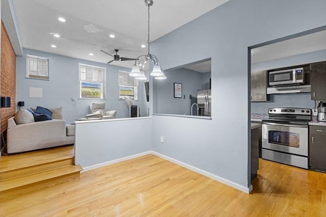 80 Beaumont St Unit 101, Boston, MA 02124 - kitchen featuring appliances with stainless steel finishes, recessed lighting, light wood-style flooring, open floor plan, and pendant lighting