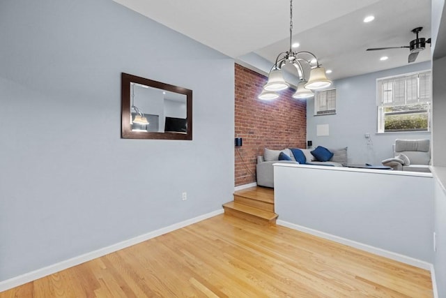 80 Beaumont St Unit 101, Boston, MA 02124 - living room featuring brick wall, wood finished floors, a chandelier, ceiling fan, and recessed lighting