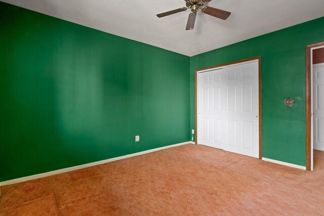 unfurnished bedroom with baseboards, a ceiling fan, and carpet