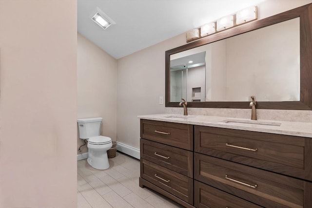 full bath featuring a sink, baseboards, toilet, and double vanity