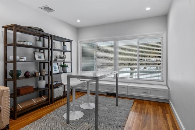 office space featuring recessed lighting, visible vents, baseboards, and wood finished floors