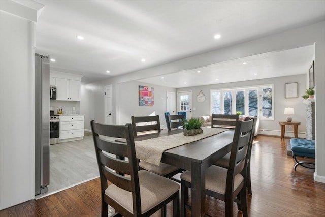 dining area featuring hardwood / wood-style floors and baseboard heating