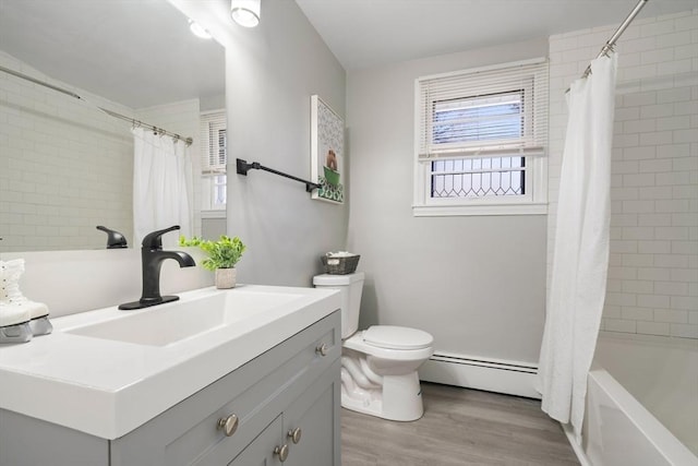 full bathroom featuring hardwood / wood-style floors, shower / bath combination with curtain, vanity, baseboard heating, and toilet