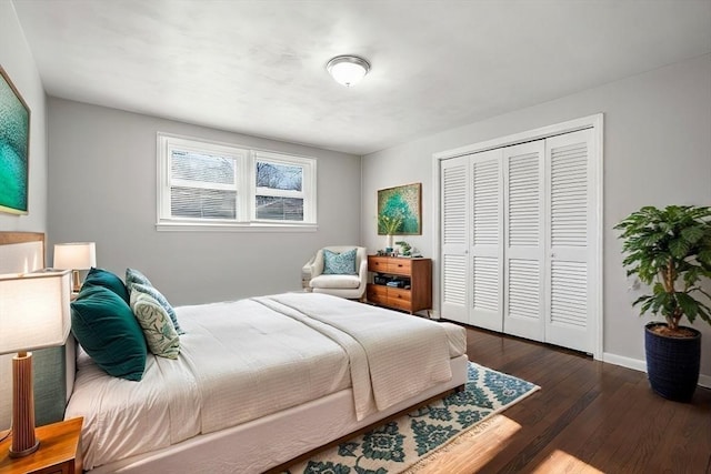 bedroom with dark wood-type flooring and a closet