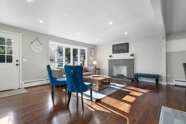 living room featuring a baseboard radiator, plenty of natural light, and dark hardwood / wood-style floors