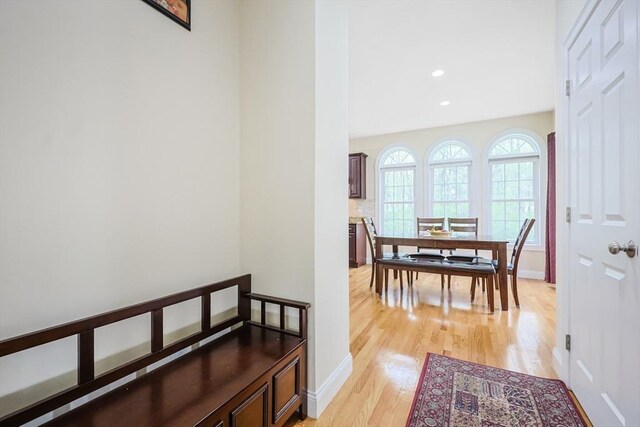 hallway with recessed lighting, baseboards, and light wood-style floors