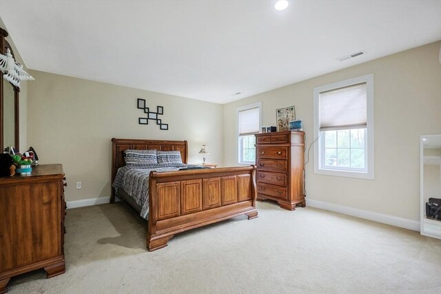 bedroom with light carpet, baseboards, and visible vents