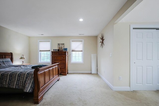 carpeted bedroom with baseboards, multiple windows, recessed lighting, and visible vents
