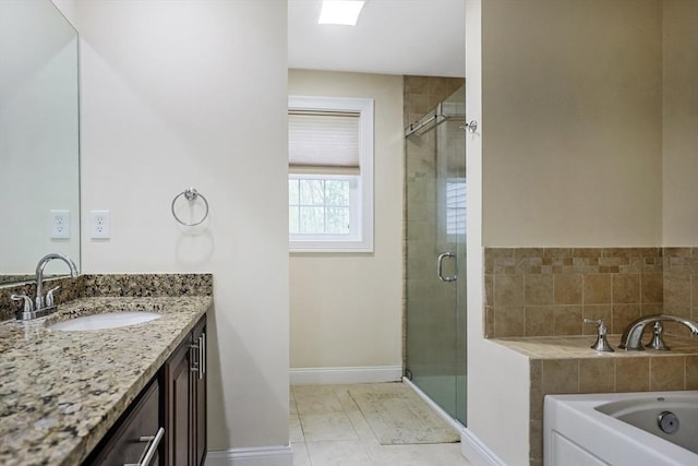 bathroom with a bath, a shower stall, baseboards, and vanity