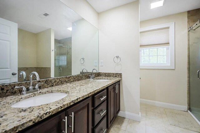 full bath featuring a sink, a stall shower, baseboards, and visible vents