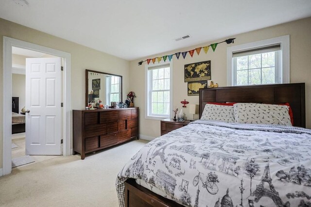 carpeted bedroom with baseboards and visible vents