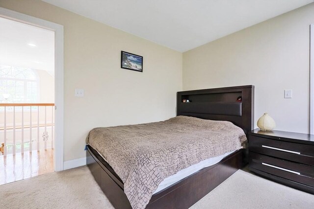 carpeted bedroom featuring baseboards