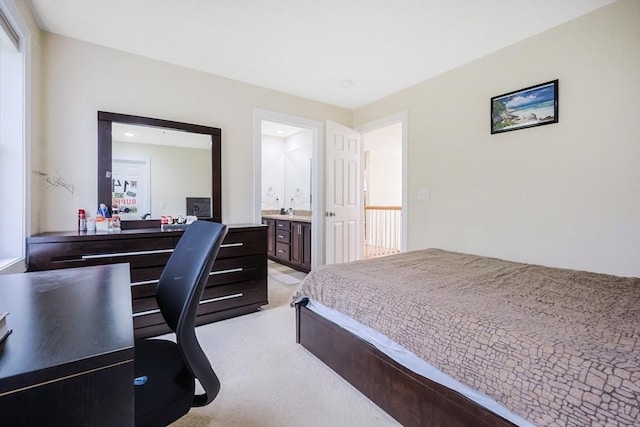bedroom with light carpet and connected bathroom