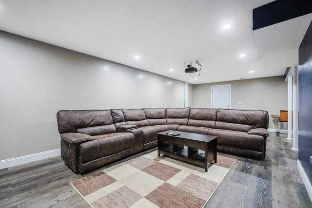 living area with wood finished floors, baseboards, and recessed lighting