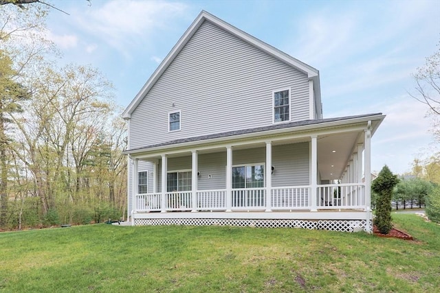 back of house with covered porch and a lawn