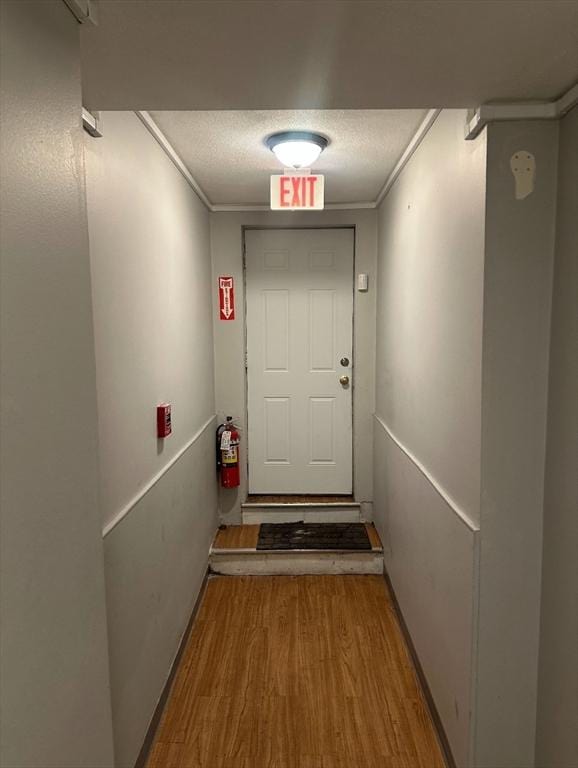 7 Esmond St, Boston, MA 02121 - doorway to outside with a textured ceiling, wood finished floors, and crown molding
