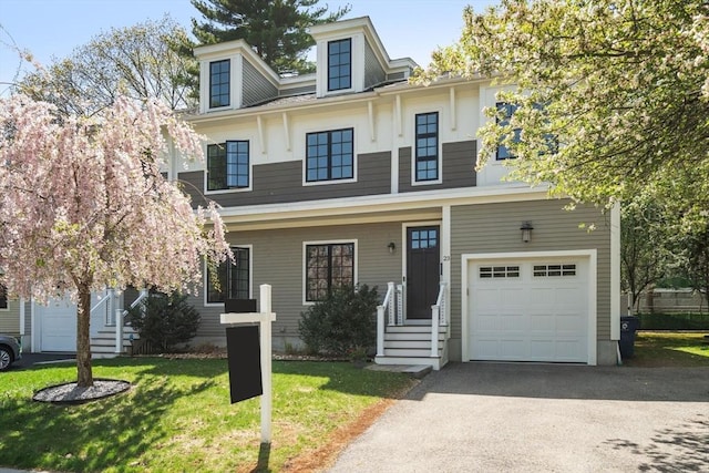 view of front of house with an attached garage, driveway, and a front yard