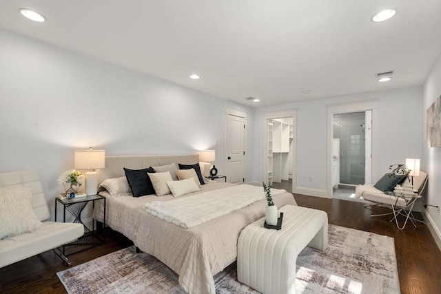 bedroom featuring a walk in closet, baseboards, recessed lighting, and dark wood-style floors