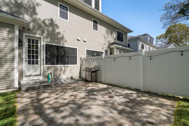 view of patio featuring a gate, fence, and area for grilling