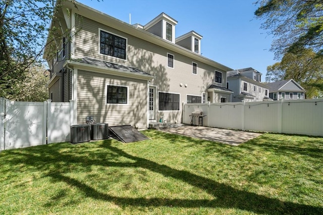 back of house with a patio, a fenced backyard, central air condition unit, and a yard