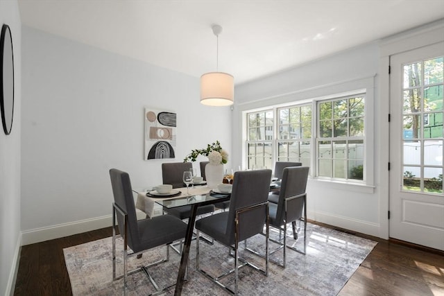 dining area with baseboards, wood finished floors, and visible vents