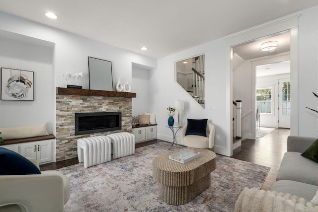 living room featuring recessed lighting, stairs, wood finished floors, and a fireplace