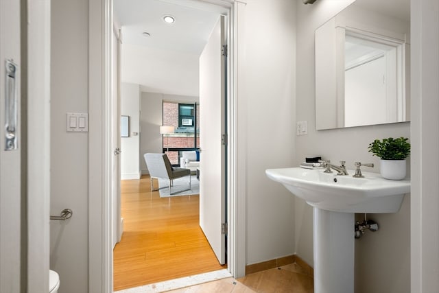 bathroom featuring hardwood / wood-style floors and toilet