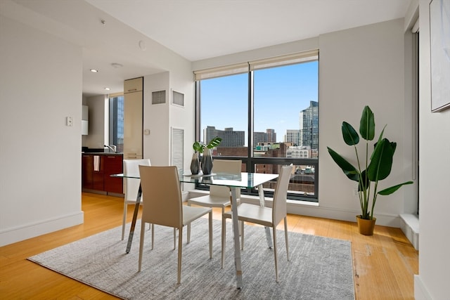 dining space with light hardwood / wood-style floors