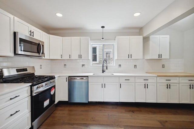 kitchen featuring white cabinetry, light countertops, appliances with stainless steel finishes, and a sink