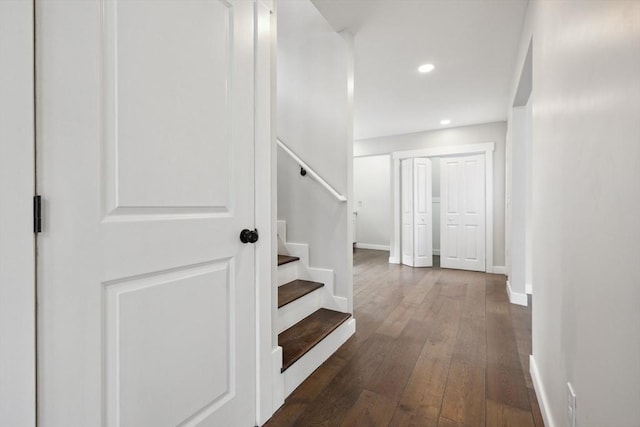 corridor with stairs, recessed lighting, dark wood-style floors, and baseboards