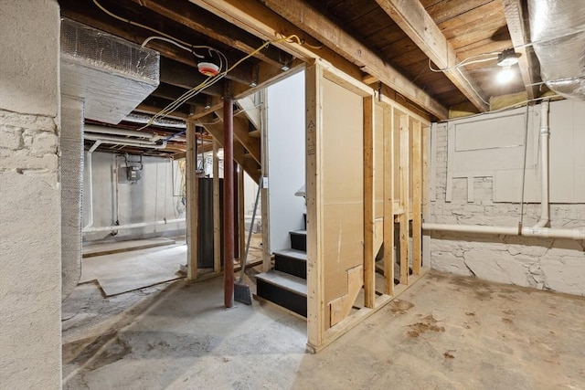 unfinished basement featuring stairway