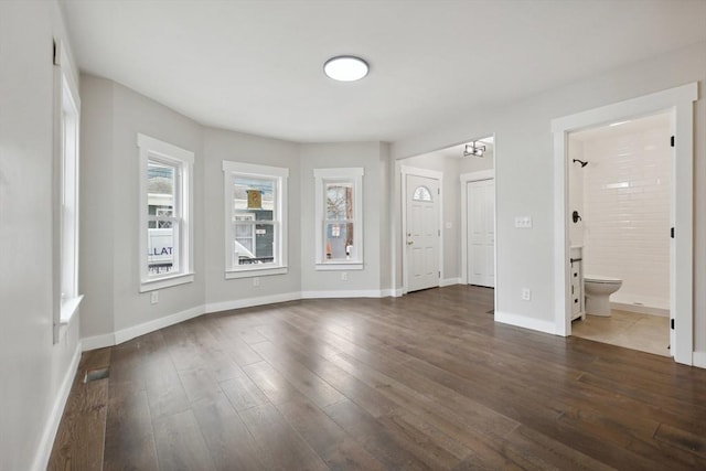 interior space featuring dark wood finished floors and baseboards