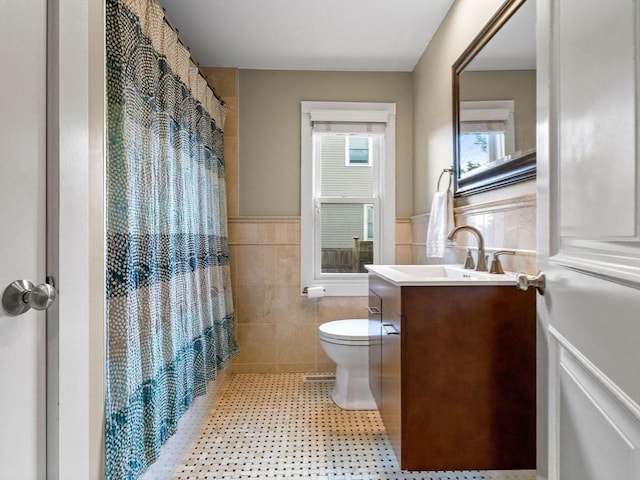 83 Altamont Ave, Melrose, MA 02176 - bathroom featuring tile walls, toilet, vanity, wainscoting, and a shower with shower curtain