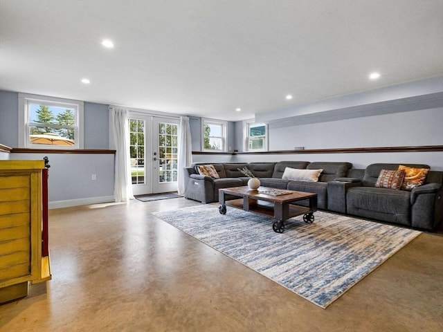 83 Altamont Ave, Melrose, MA 02176 - living area with french doors, finished concrete flooring, baseboards, and recessed lighting