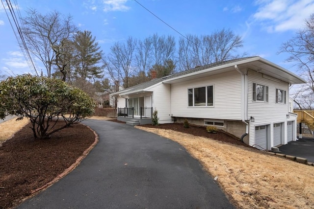 view of home's exterior featuring aphalt driveway and an attached garage