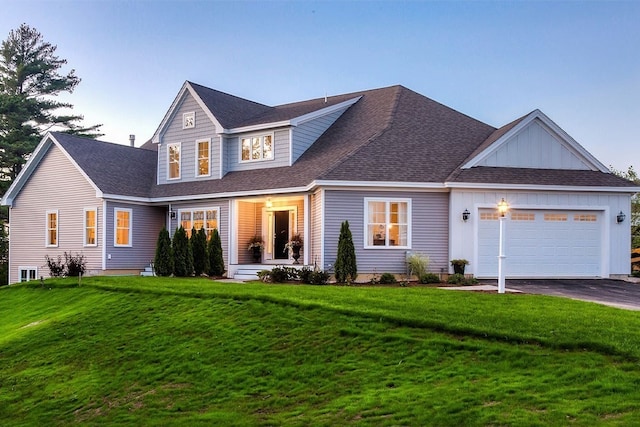 view of front of home with a front yard and a garage