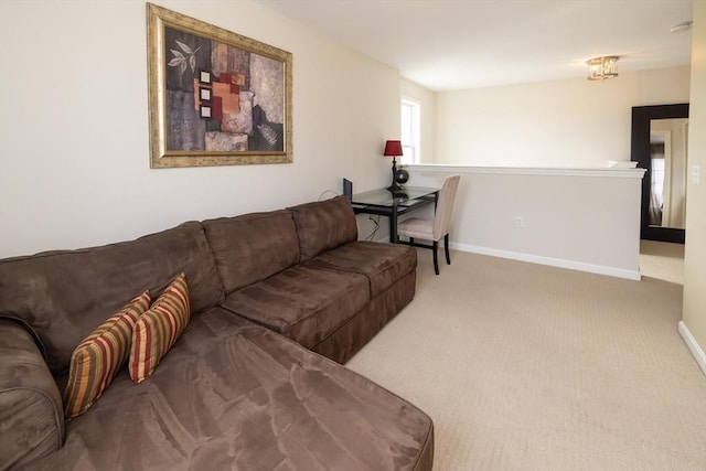 carpeted living room with baseboards