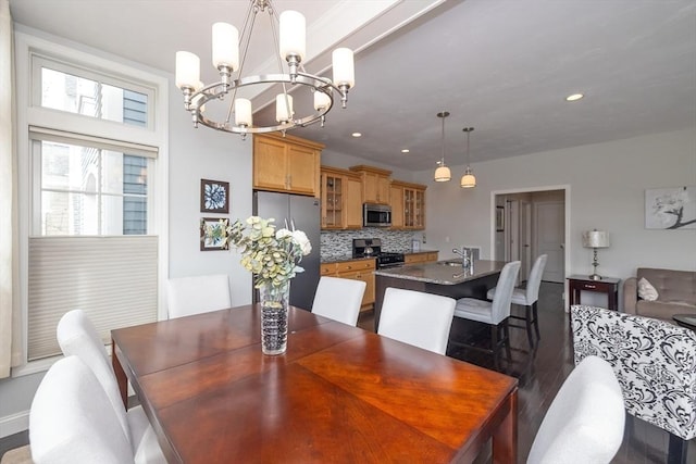 dining space with dark wood-style floors, an inviting chandelier, and recessed lighting