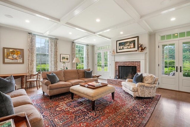 living room with french doors, beamed ceiling, coffered ceiling, and a wealth of natural light