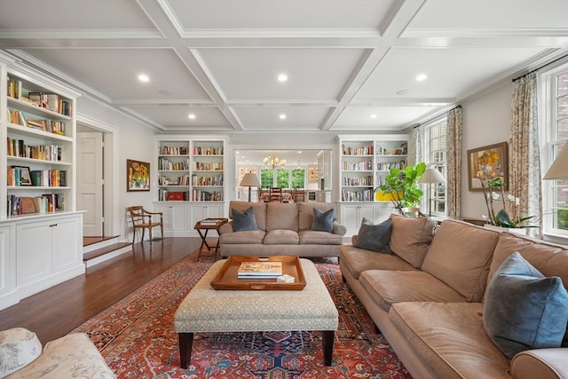 living room featuring coffered ceiling, dark hardwood / wood-style floors, built in features, and a wealth of natural light