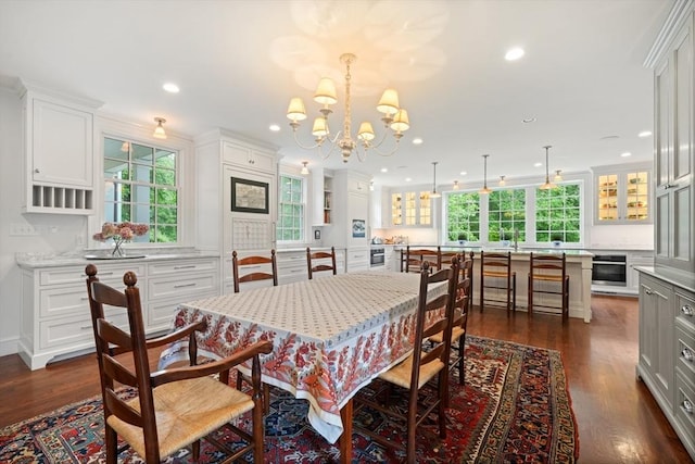 dining room with plenty of natural light, beverage cooler, and dark hardwood / wood-style flooring