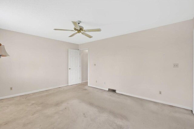 spare room featuring baseboards, a ceiling fan, and visible vents
